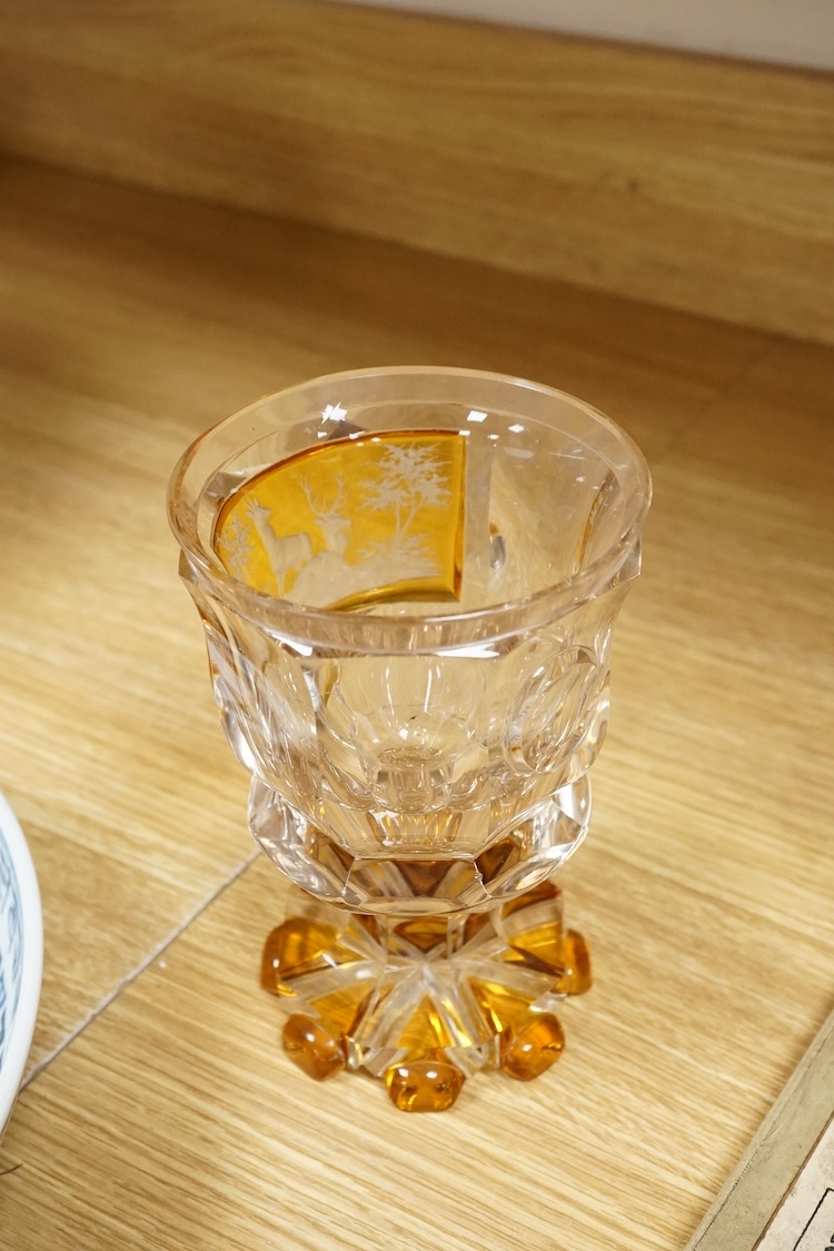 A heavy Bohemian amber flashed glass goblet, late 19th century, decorated with deer, 17cm high